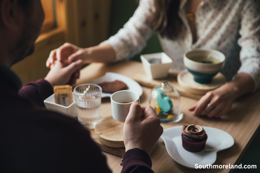Couple enjoying coffee and dessert during a romantic Kansas City date
