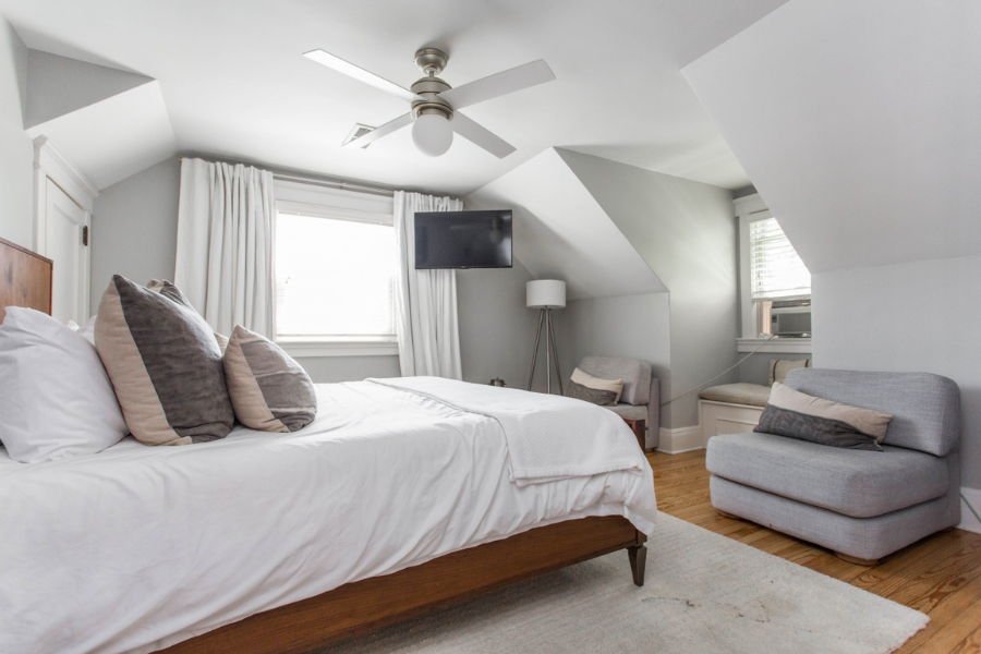 Bright guest room at a boutique hotel in Kansas City with king bed and sitting area